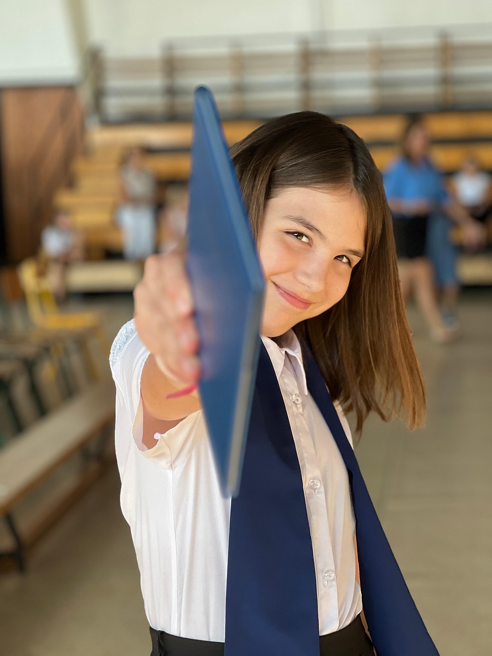 Girl holding book smiling